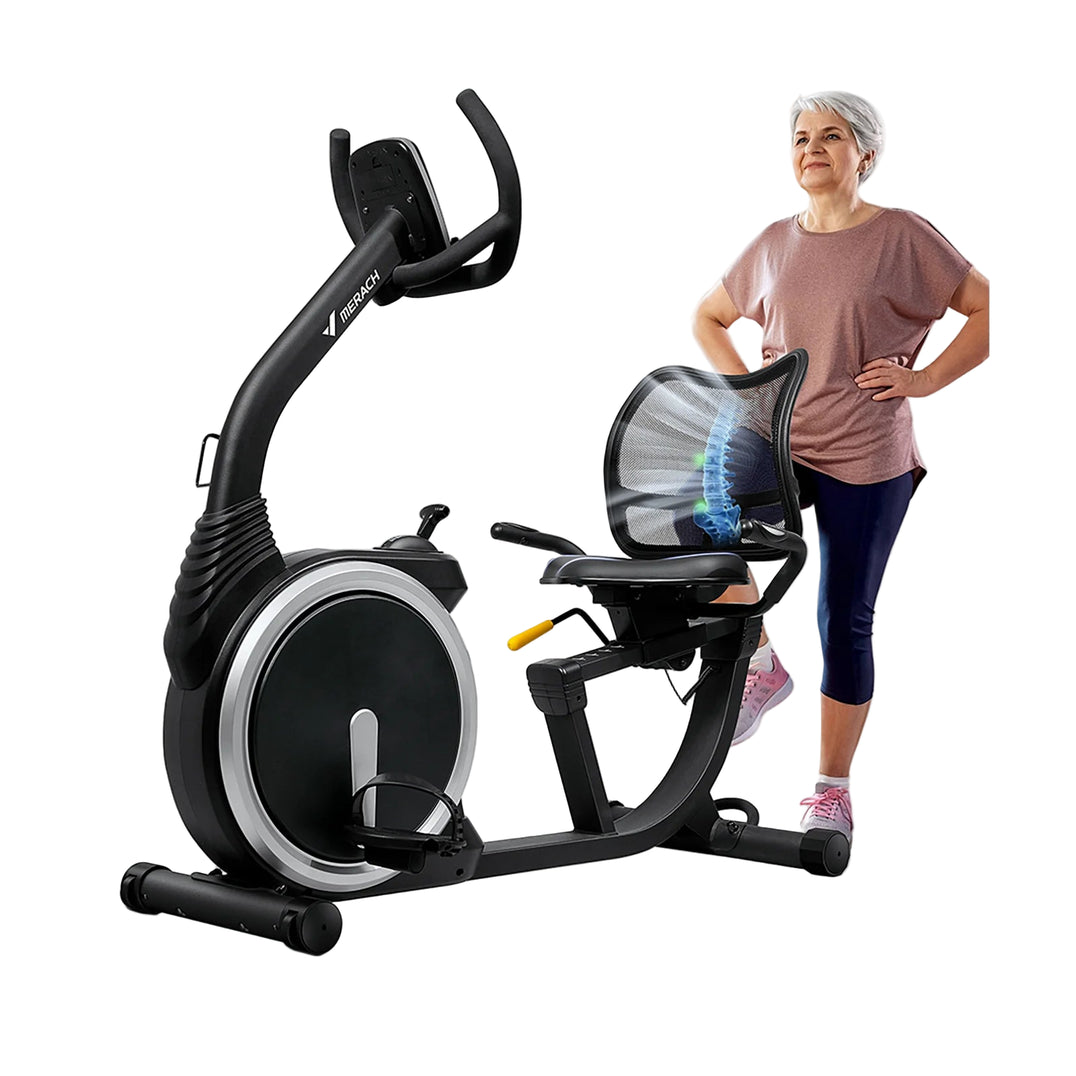 An image showing a recumbent exercise bike with a woman standing next to it. The bike is black with a comfortable seat, frosted handlebars, and a heart rate monitor.
