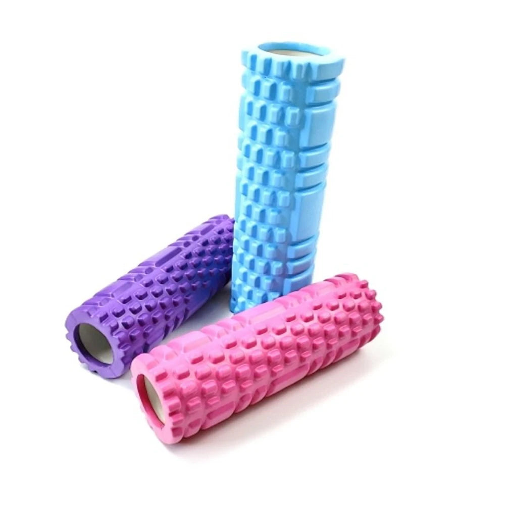 Three foam rollers in purple, blue, and pink on a white background