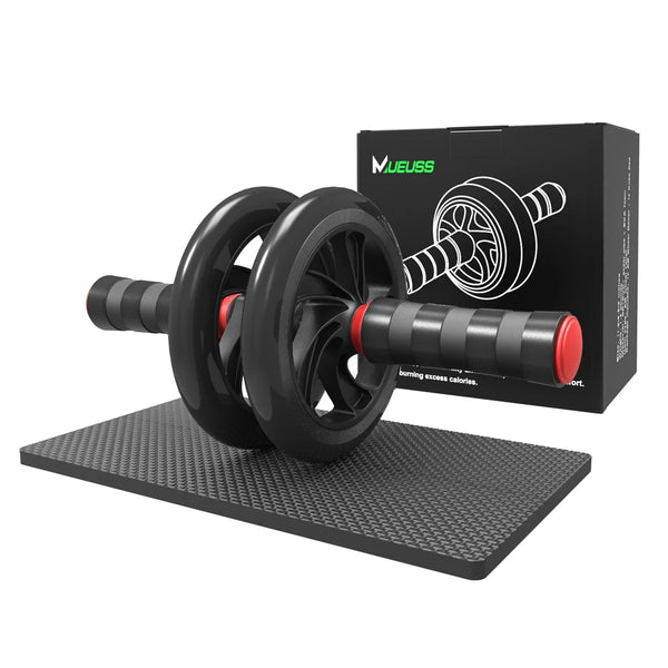 Black ab roller with red accents on a black mat, next to its packaging box.