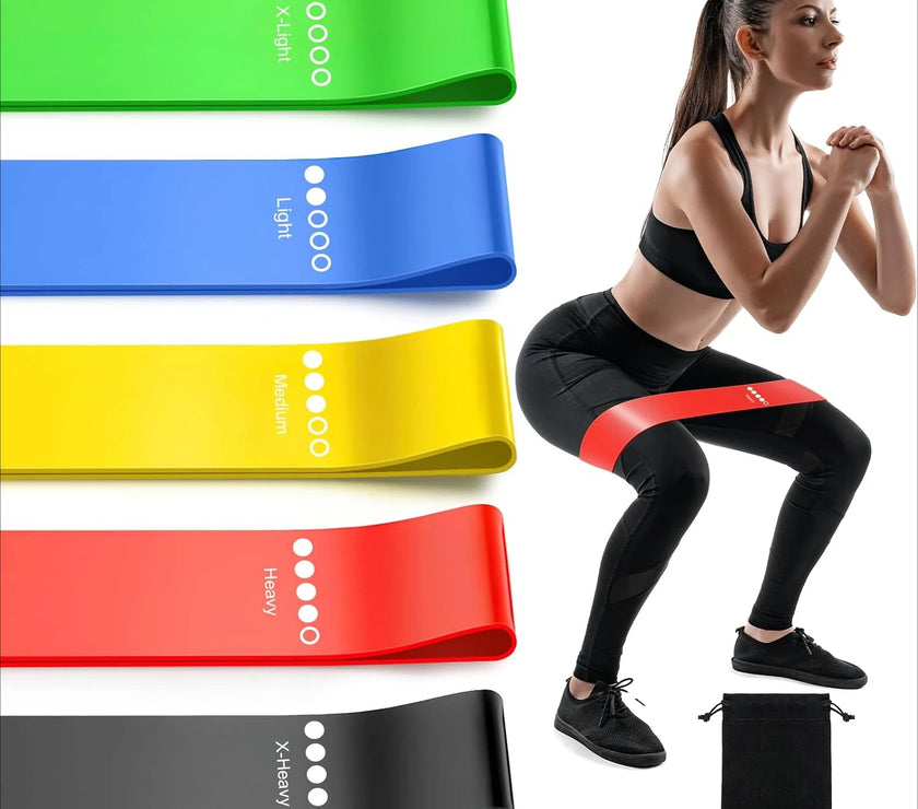 Resistance bands in various colors with a woman exercising using them.