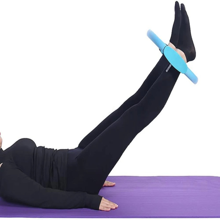 Person using a blue foam roller on a purple mat with a white background