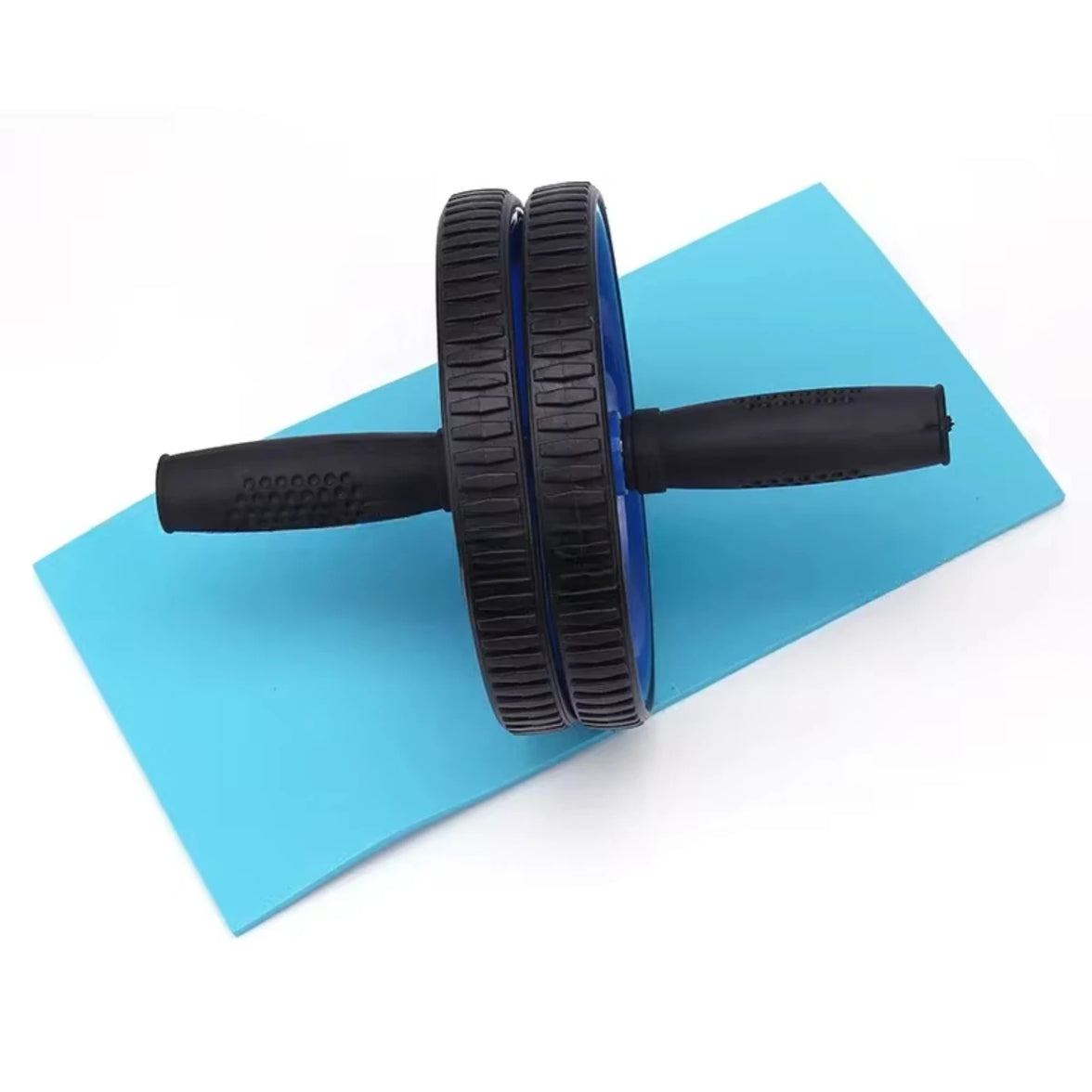 Black ab roller on a blue exercise mat with a white background