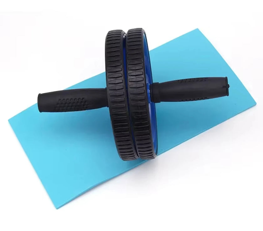 Black ab roller on a blue exercise mat with a white background