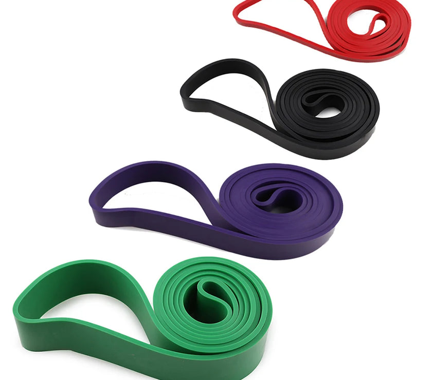 Set of resistance bands in red, black, purple, and green on a white background