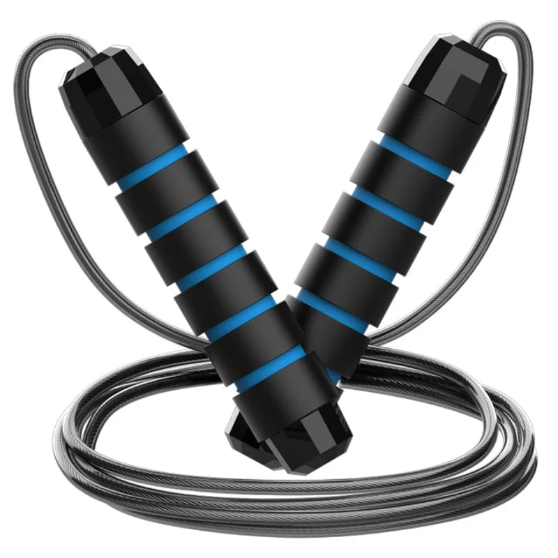 An adjustable jump rope with steel wire and black and red handles lying on a reflective surface.