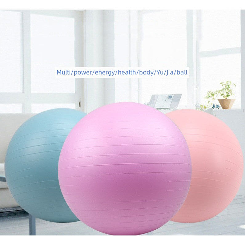 Three exercise balls in blue, pink, and red on a light background