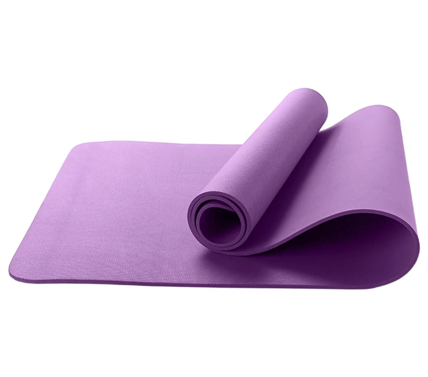 Purple yoga mat rolled up on a white background