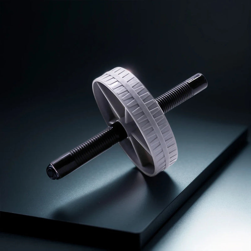 White ab roller on a reflective black surface with a dark background