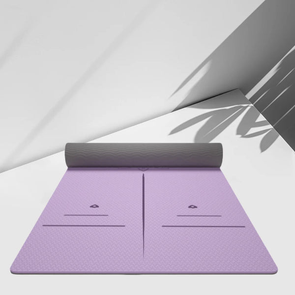 Purple yoga mat with a rolled-up gray mat on a white surface