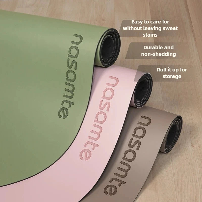 Three rolled-up yoga mats with 'nasamonte' branding on a wooden floor.