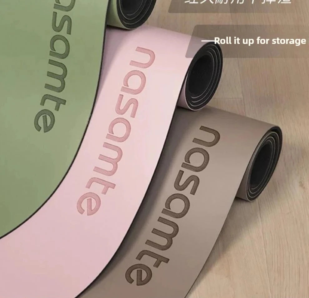 Three rolled-up yoga mats with 'nasomte' branding on a wooden floor.
