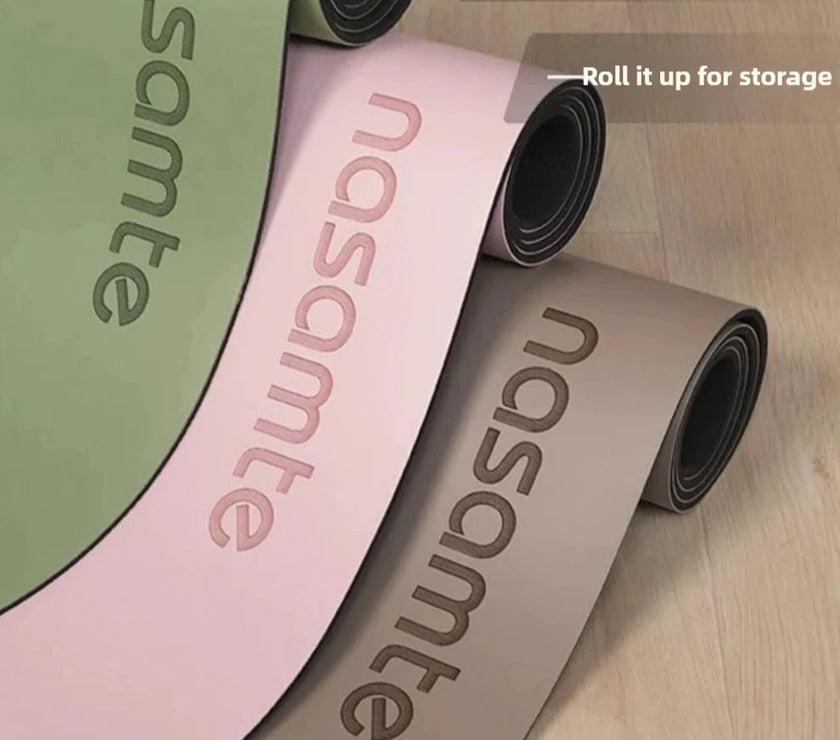 Three rolled-up yoga mats with 'nasomte' branding on a wooden floor.