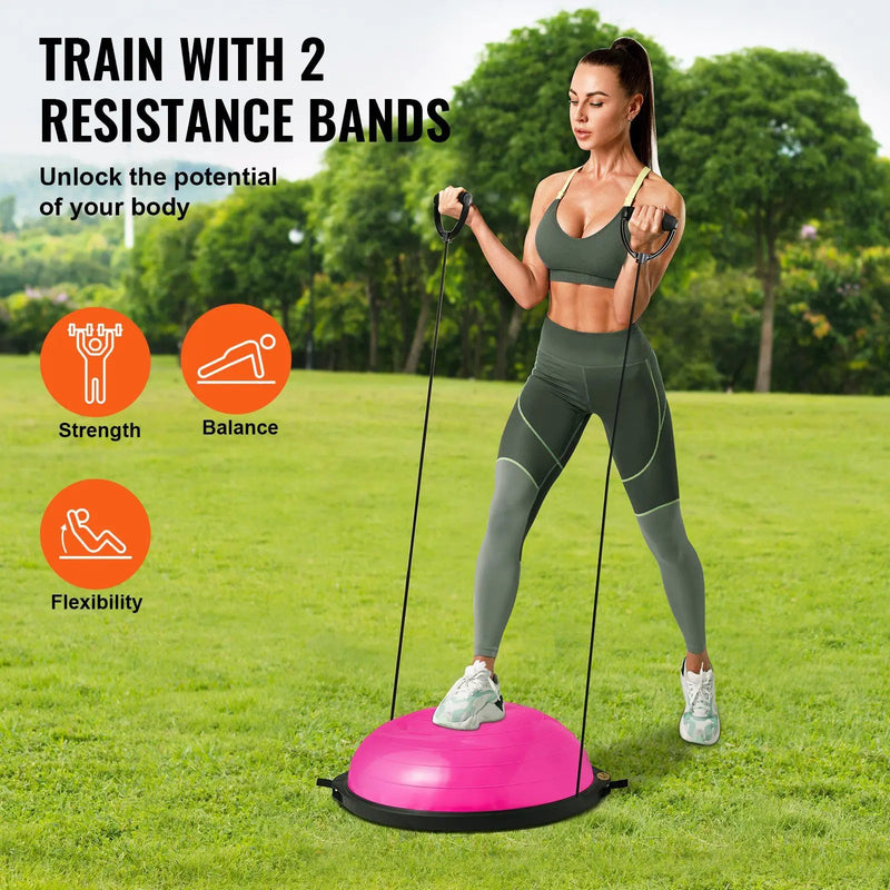 Woman exercising with resistance bands on a grassy field