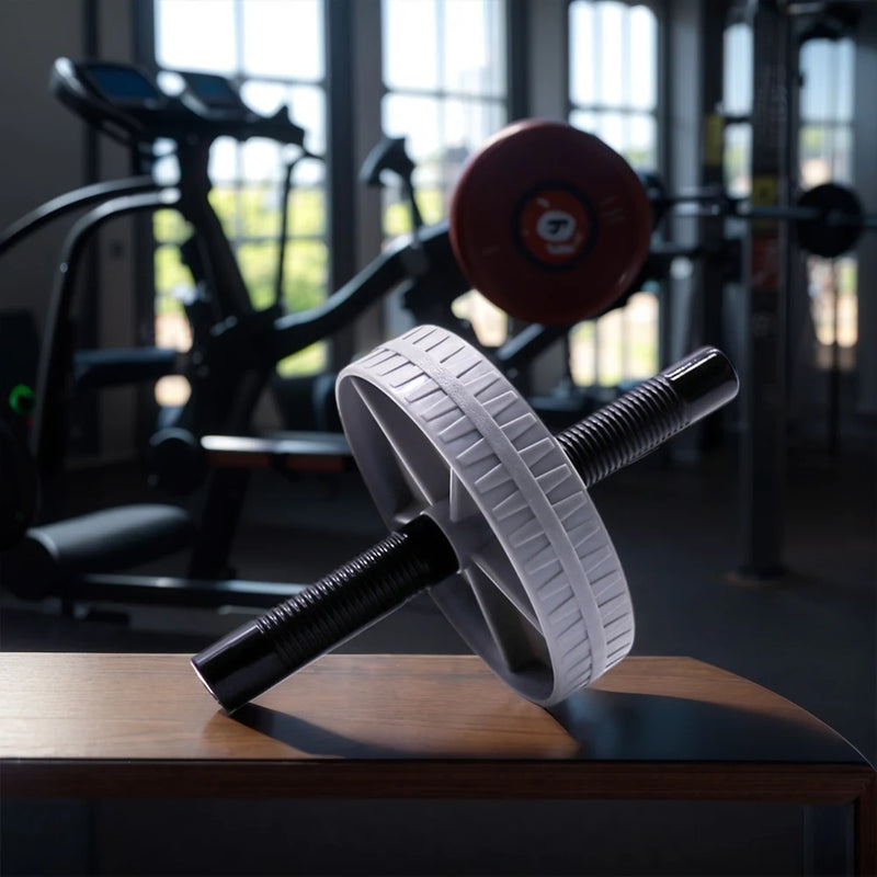 Ab roller on a table in a gym setting with blurred background