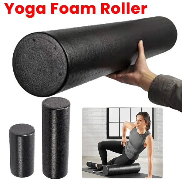Black yoga foam roller held by a hand with additional rollers and a person using it in a gym setting.