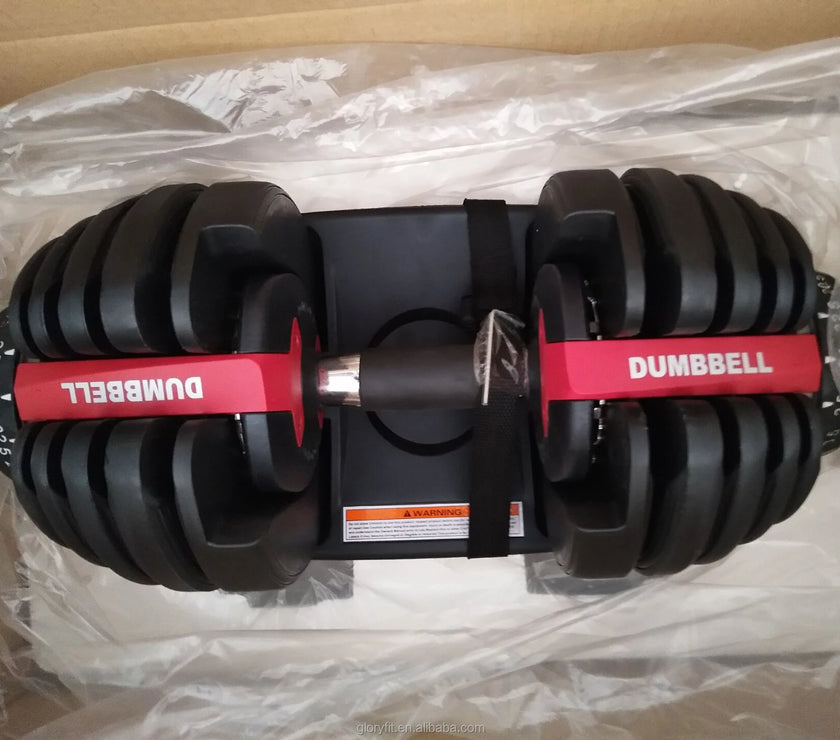 Pair of adjustable dumbbells on a clear plastic sheet