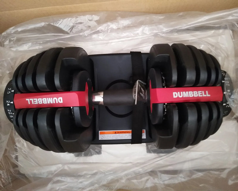 Pair of adjustable dumbbells on a clear plastic sheet