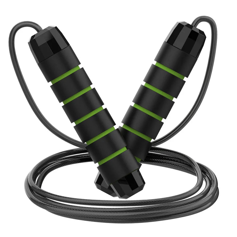 An adjustable jump rope with steel wire and black and red handles lying on a reflective surface.