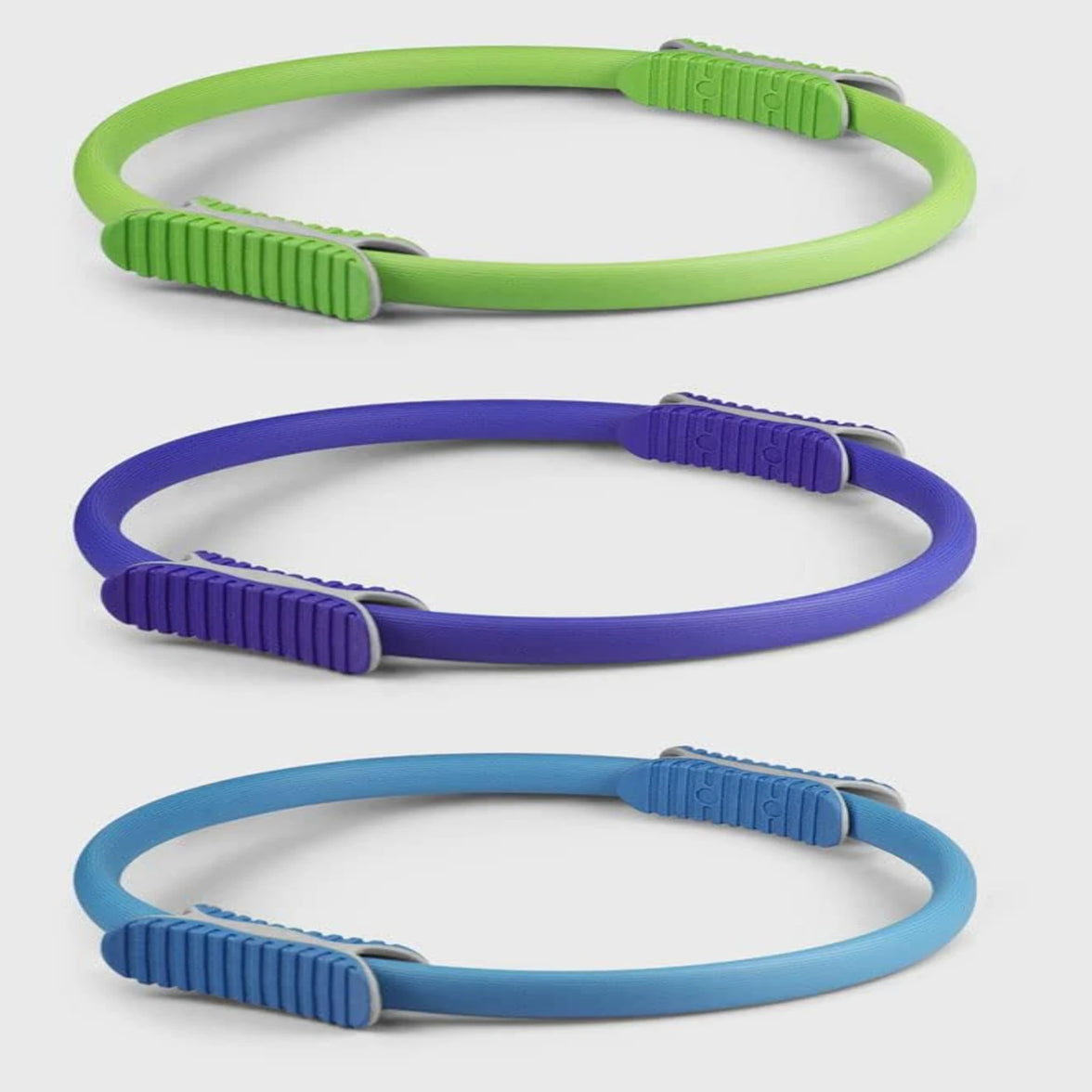 Three colorful dog leashes in green, purple, and blue on a white background