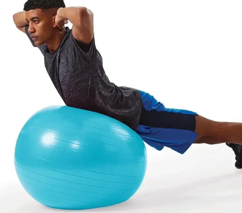 Man exercising on a blue fitness ball against a white background