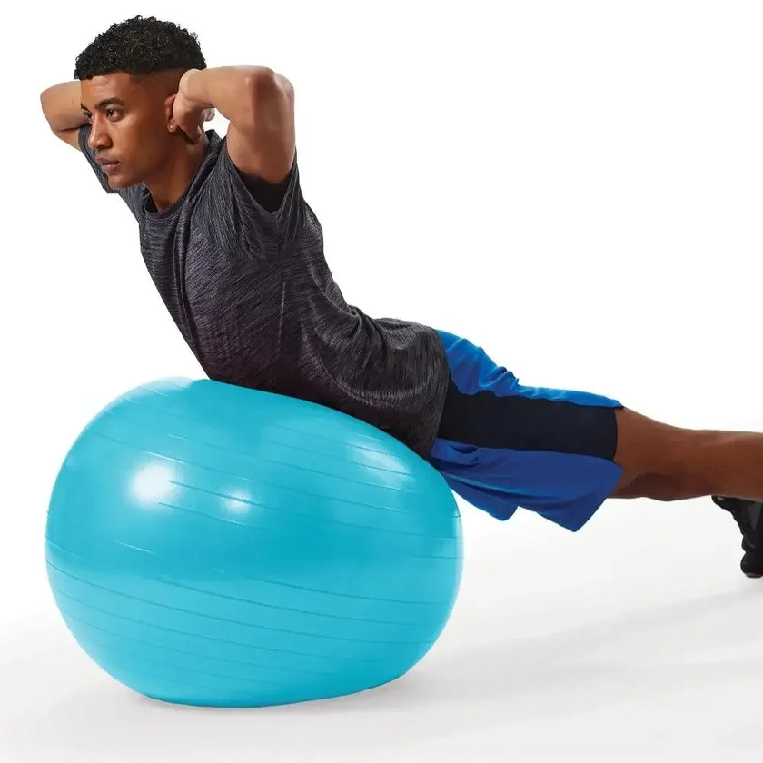 Man exercising on a blue fitness ball against a white background