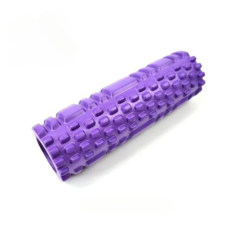 A set of four yoga rollers in black, blue, pink, and purple colors, each featuring a textured surface for muscle activation.