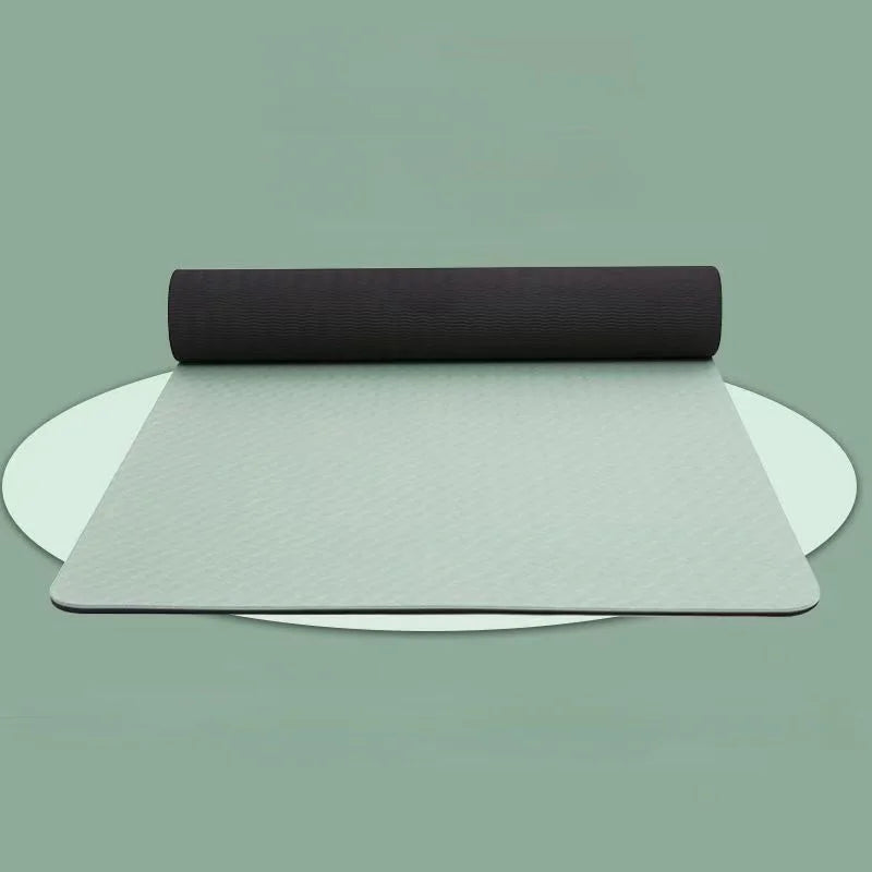 Two yoga mats, one black and one gray, on a light green background