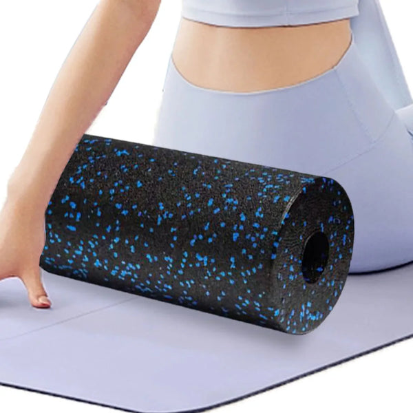 Person holding a black and blue foam roller on a light gray mat