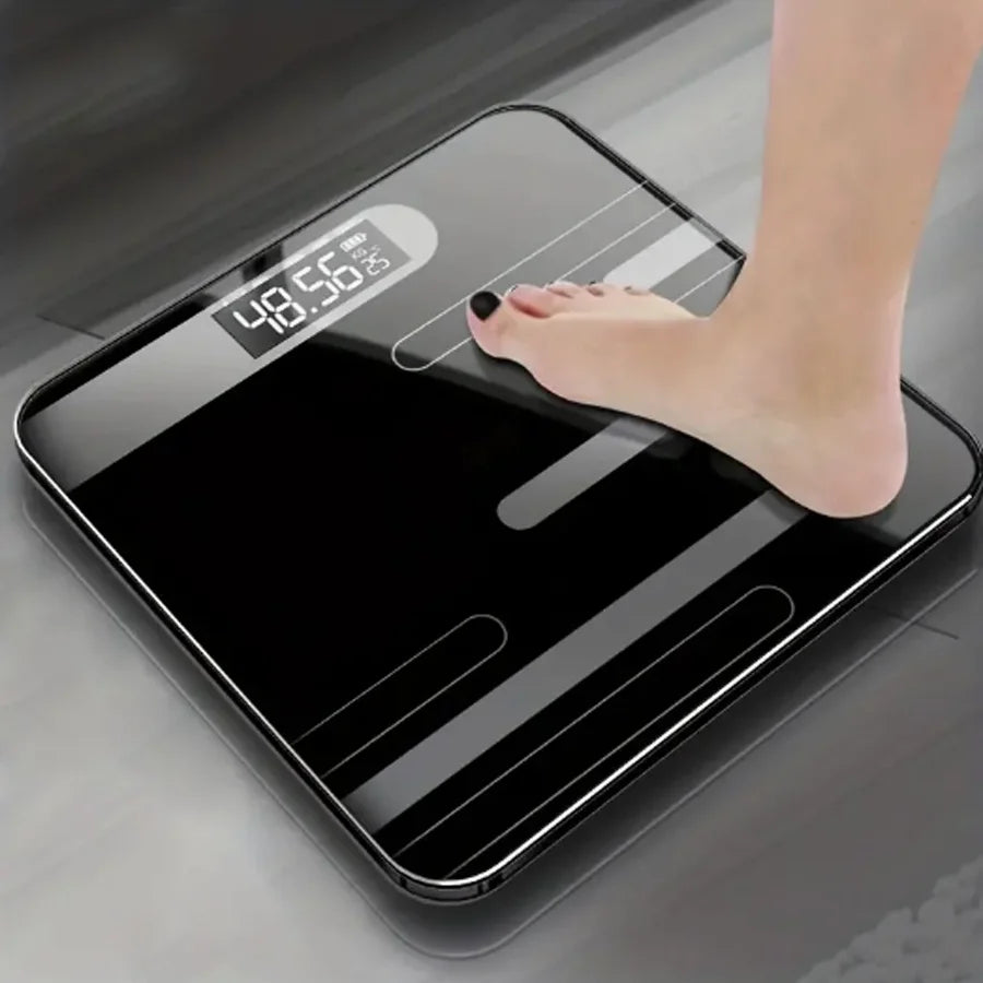 Digital bathroom scale with a foot stepping on it, displaying weight.