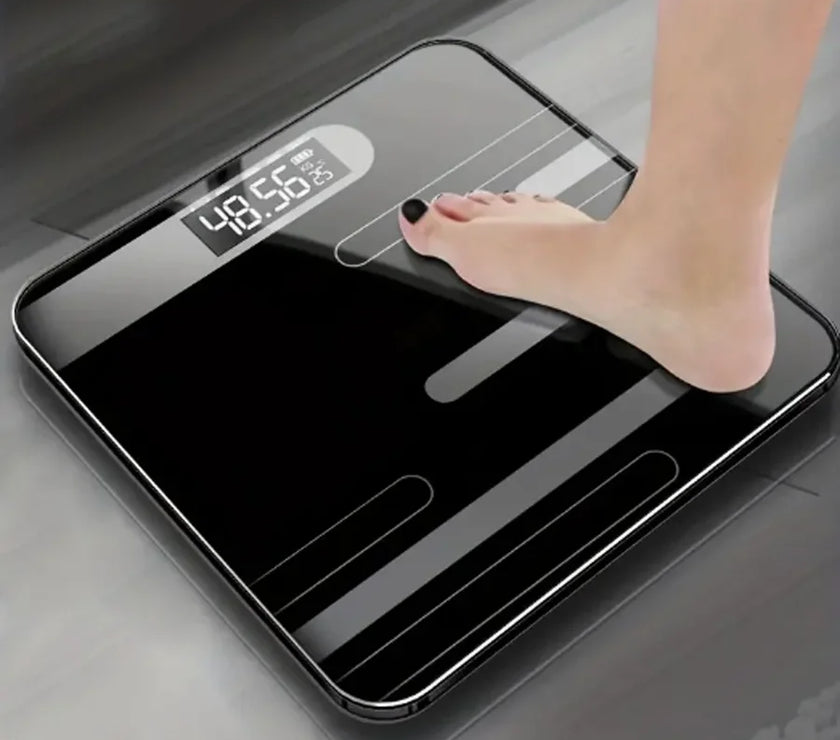 Digital bathroom scale with a foot stepping on it, displaying weight.