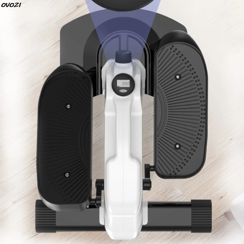 Mini stepper exercise machine on a wooden floor with 'OVOZI' branding.