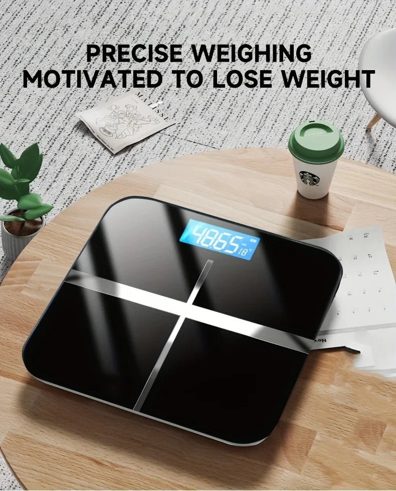 Digital bathroom scale on a wooden table with a Starbucks cup and plant in the background.