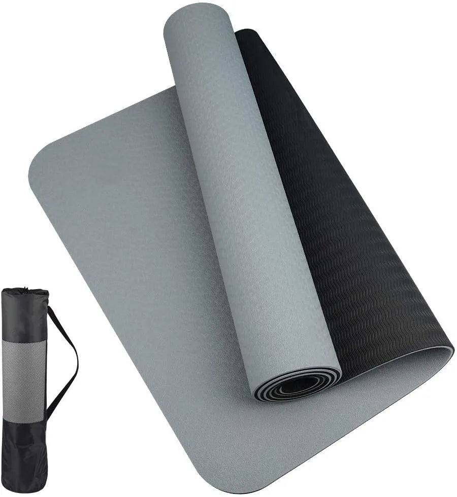 Gray and black yoga mat with carrying strap on a white background
