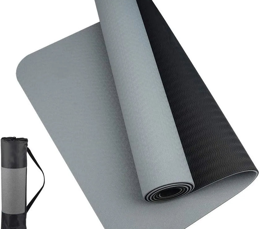 Gray and black yoga mat with carrying strap on a white background