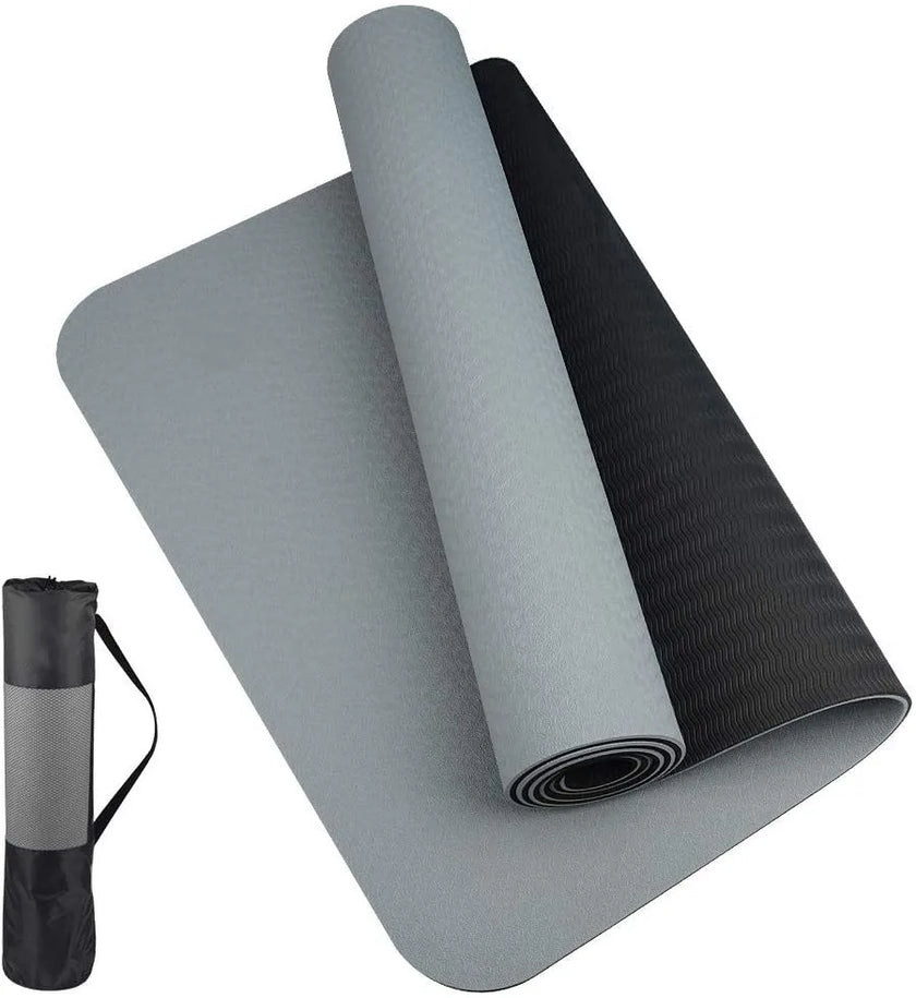Gray and black yoga mat with carrying strap on a white background